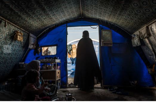 30-year-old mother of six, Amina, stands inside her tent at Hamam al Alil camp for internally displaced persons in northern Iraq