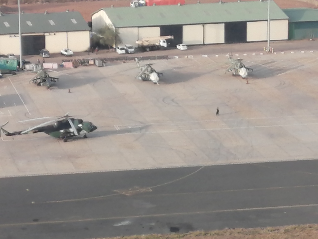 This image shows three of four Mi-24 attack helicopters that South Sudan purchased from Ukraine in 2015. When the arms embargo was instituted in July 2018, these helicopters were in disrepair and unserviceable, unable to fly. However, during the embargo the helicopters underwent maintenance and repairs, using components imported in violation of the embargo. These ones are pictured at Juba International Airport (JIA) in early 2020. © Amnesty International