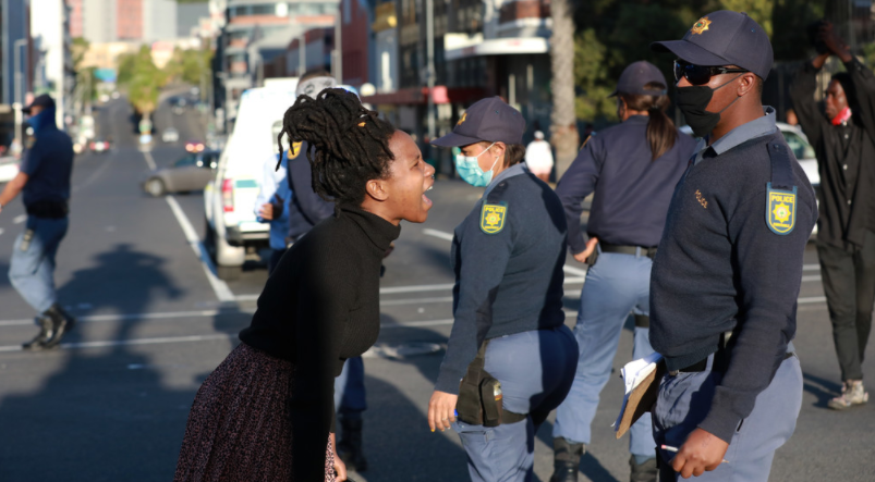 Woman confronting police during a GBV protest
