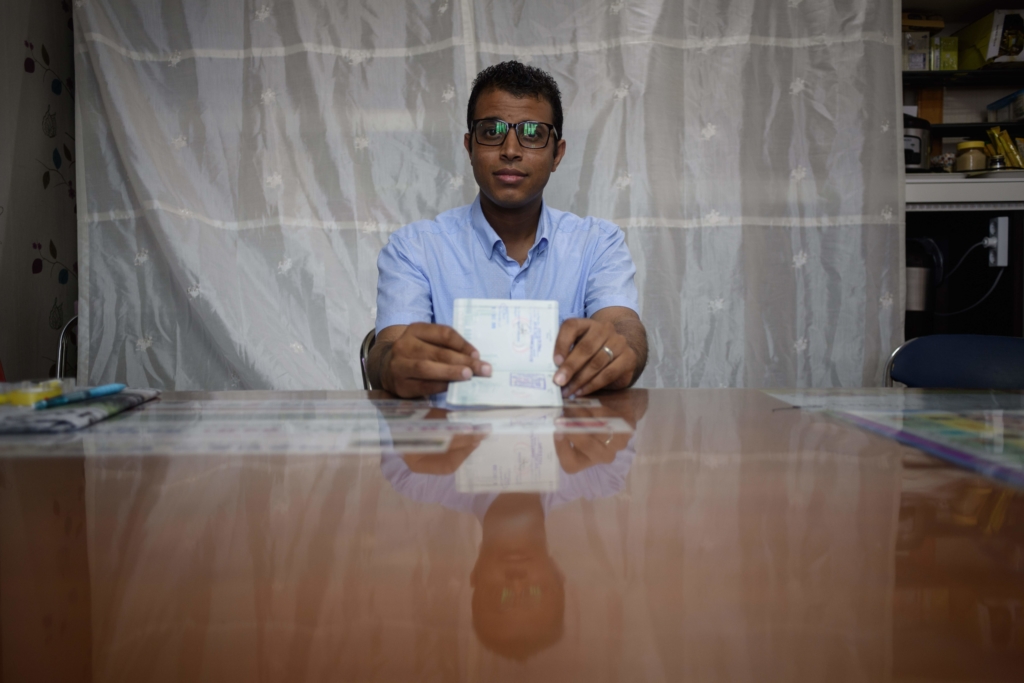 Yemeni asylum seeker Mohammed Salem Duhaish, 33, shows his South Korean visa while sitting in a room at the office of Jeju NGO Network for Refugee Rights in Jeju.  ED JONES/AFP/Getty Images