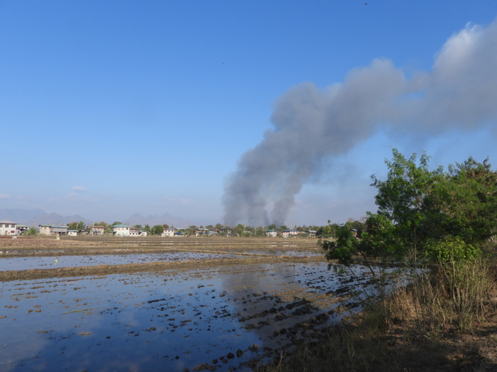 Smoke billowing from Wari Suplai village, in southern Shan State, after buildings were set on fire by the Myanmar military, 18 February 2022. Well over two thirds of the houses in the village were destroyed in February; soldiers set more alight in March.