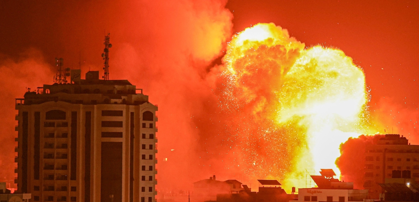 A fireball erupts from an Israeli airstrike in Gaza City on October 9, 2023.