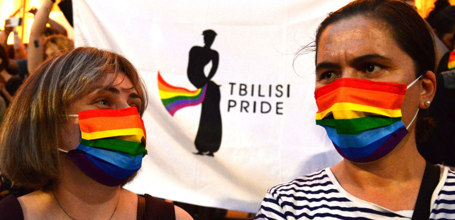 Participants wear rainbow protective masks during a rally in support of those who were injured during the July 5 protests, when a pride march was disrupted by members of violent groups, in Tbilisi on July 6, 2021. - Thousands rallied in the Georgian capital Tbilisi on Tuesday to denounce attacks targeting LGBTQ community and journalists that shocked the nation and forced activists to cancel a Pride march