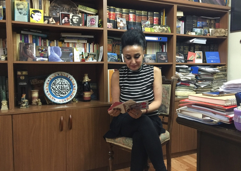 Eren Keskin sits in an office, reading solidarity messages