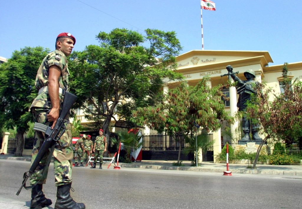 Lebanese soldiers stand guard outside the military court in Beirut 11 August 2001