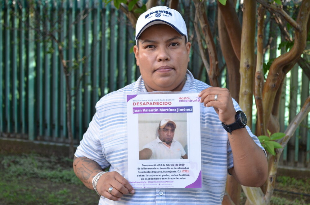 Karla holds a picture of her brother, who disappeared violently. 