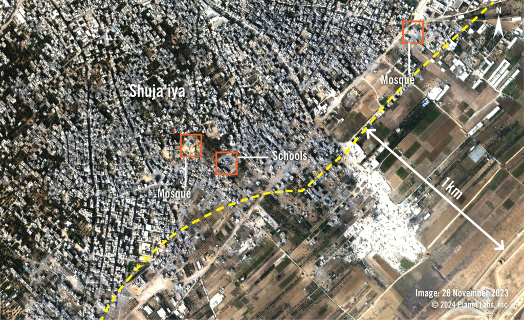 Satellite image show a town before it was destroyed. Red squares highlight the location of two mosques and  schools within a yellow dotted line showing the 1km mark.